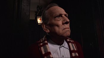 Movie still from “The Tenant” (1976), directed by Roman Polanski – An old man wearing a red and white striped scarf; Close Up shot, Low angle