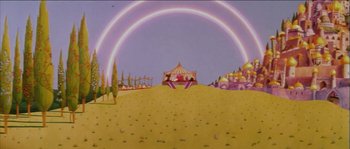A circus tent with a rainbow in the background