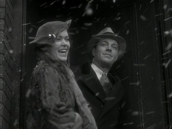 Movie still from “The Thin Man” (1934), directed by W.S. Van Dyke – A man and a woman standing next to each other in the snow; Medium shot, Low angle