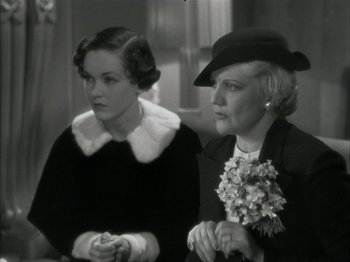 Movie still from “The Thin Man” (1934), directed by W.S. Van Dyke – Two women are sitting next to each other in a room; Close Up shot, High angle
