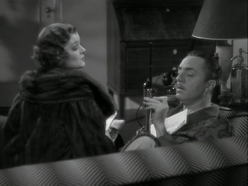 Movie still from “The Thin Man” (1934), directed by W.S. Van Dyke – An old photo of a man and a woman talking on a phone; Medium shot, High angle