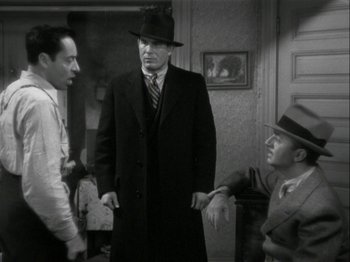 Movie still from “The Thin Man” (1934), directed by W.S. Van Dyke – A group of men standing next to each other in a room; Medium shot, Over the shoulder angle