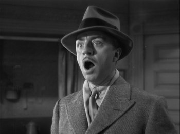 Movie still from “The Thin Man” (1934), directed by W.S. Van Dyke – A man wearing a suit and a hat with his mouth open; Close Up shot, Low angle
