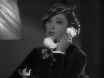 Movie still from “The Thin Man” (1934), directed by W.S. Van Dyke – A black and white photo of a woman talking on a phone; Close Up shot, High angle