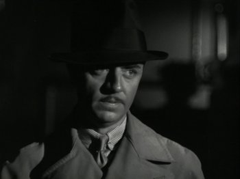 Movie still from “The Thin Man” (1934), directed by W.S. Van Dyke – A black and white photo of a man wearing a hat; Close Up shot, Low angle