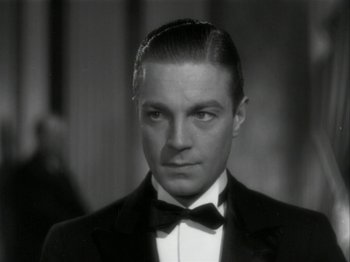 Movie still from “The Thin Man” (1934), directed by W.S. Van Dyke – A black and white photo of a man in a tuxedo; Close Up shot, Low angle