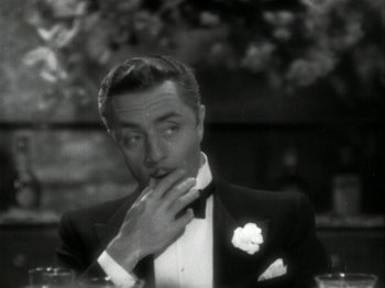 Movie still from “The Thin Man” (1934), directed by W.S. Van Dyke – An old photo of a man in a suit and bow tie; Close Up shot, High angle