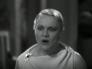 Movie still from “The Thin Man” (1934), directed by W.S. Van Dyke – An old photo of a woman with a surprised look on her face; Close Up shot, Low angle