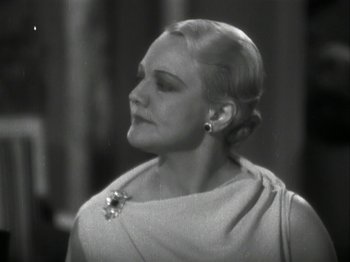 Movie still from “The Thin Man” (1934), directed by W.S. Van Dyke – An old photo of a woman in a dress looking to her left; Close Up shot, Low angle