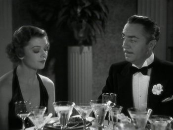 Movie still from “The Thin Man” (1934), directed by W.S. Van Dyke – A man and a woman sitting at a dinner table; Medium shot, High angle