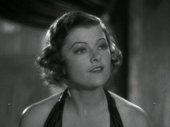 Movie still from “The Thin Man” (1934), directed by W.S. Van Dyke – An old photo of a woman in a black dress; Close Up shot, High angle