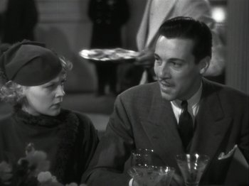 Movie still from “The Thin Man” (1934), directed by W.S. Van Dyke – A man and a woman sitting at a dinner table; Medium shot, Over the shoulder angle