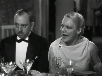 Movie still from “The Thin Man” (1934), directed by W.S. Van Dyke – A man and a woman sitting at a dinner table; Close Up shot, Low angle