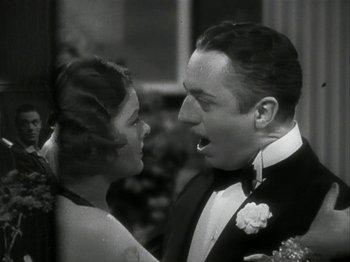 Movie still from “The Thin Man” (1934), directed by W.S. Van Dyke – A man and a woman in formal wear looking at each other; Close Up shot, Low angle