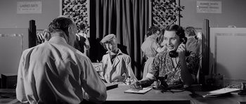 Movie still from “The Three Faces of Eve” (1957), directed by Nunnally Johnson – A group of people sitting around a table; Medium shot, Over the shoulder angle