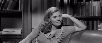 Movie still from “The Three Faces of Eve” (1957), directed by Nunnally Johnson – A black - and - white photo of a woman sitting in a chair; Close Up shot, Low angle