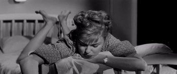 Movie still from “The Three Faces of Eve” (1957), directed by Nunnally Johnson – A black - and - white photo of a woman holding a towel; Close Up shot, High angle
