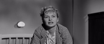 Movie still from “The Three Faces of Eve” (1957), directed by Nunnally Johnson – An old photo of an older woman with blonde curly hair; Close Up shot, Low angle