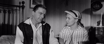 Movie still from “The Three Faces of Eve” (1957), directed by Nunnally Johnson – An older man and a younger woman are talking; Medium shot, Over the shoulder angle