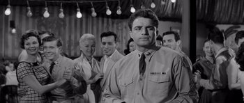 Movie still from “The Three Faces of Eve” (1957), directed by Nunnally Johnson – Black and white photograph of men and women standing in a room; Medium shot, Low angle