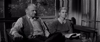 Movie still from “The Three Faces of Eve” (1957), directed by Nunnally Johnson – An older man and a younger woman sitting on a couch; Medium shot, Low angle