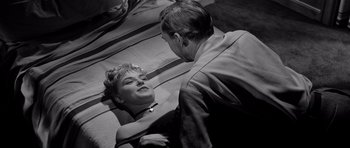 Movie still from “The Three Faces of Eve” (1957), directed by Nunnally Johnson – A man and a woman are talking to each other; Medium shot, High angle