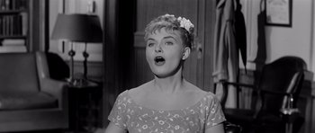 Movie still from “The Three Faces of Eve” (1957), directed by Nunnally Johnson – A black and white photo of a woman with a surprised look; Close Up shot, Low angle