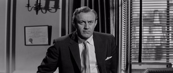 Movie still from “The Three Faces of Eve” (1957), directed by Nunnally Johnson – An older man in a suit and tie; Close Up shot, Low angle