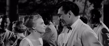 Movie still from “The Three Faces of Eve” (1957), directed by Nunnally Johnson – A man and a woman smiling at each other in a black and white photo; Close Up shot, Low angle