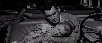 Movie still from “The Three Faces of Eve” (1957), directed by Nunnally Johnson – A black and white photo of a man and a woman hugging; Close Up shot, High angle