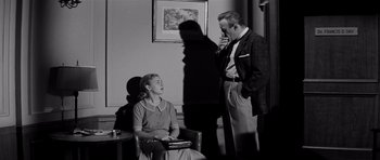 Movie still from “The Three Faces of Eve” (1957), directed by Nunnally Johnson – A man and a woman are talking to each other; Medium shot, Low angle