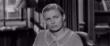 Movie still from “The Three Faces of Eve” (1957), directed by Nunnally Johnson – Black and white photograph of a woman in a room; Close Up shot, Over the shoulder angle