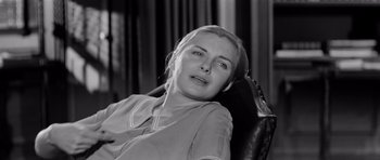 Movie still from “The Three Faces of Eve” (1957), directed by Nunnally Johnson – A black and white photo of a woman sitting in a chair; Close Up shot, High angle