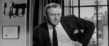 Movie still from “The Three Faces of Eve” (1957), directed by Nunnally Johnson – An old photo of a man wearing a suit and tie; Close Up shot, Low angle