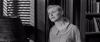 Movie still from “The Three Faces of Eve” (1957), directed by Nunnally Johnson – Black and white photograph of a woman looking off into the distance; Close Up shot, Low angle