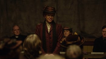 Movie still from “Anne with an E” (2017), created by Moira Walley-Beckett – A woman in a hat and a red jacket; Medium shot, Over the shoulder angle