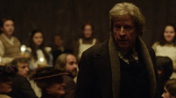 Movie still from “Anne with an E” (2017), created by Moira Walley-Beckett – A group of people standing in a room; Close Up shot, Over the shoulder angle