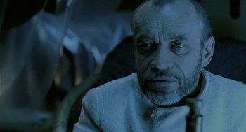 Movie still from “The Ugly Swans” (2006), directed by Konstantin Lopushanskiy – An older man with a goatee and a beard; Close Up shot, Low angle