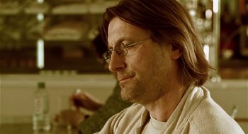 Movie still from “The Ugly Swans” (2006), directed by Konstantin Lopushanskiy – A person wearing glasses; Close Up shot, Over the shoulder angle