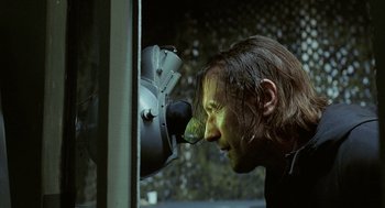 Movie still from “The Ugly Swans” (2006), directed by Konstantin Lopushanskiy – A man with green paint on his face looking into a mirror; Close Up shot, Over the shoulder angle