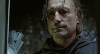 Movie still from “The Ugly Swans” (2006), directed by Konstantin Lopushanskiy – A person with a knife; Close Up shot, Low angle