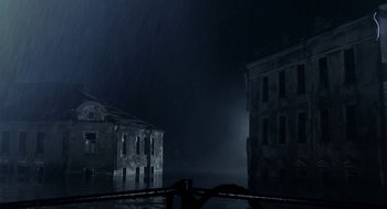 Movie still from “The Ugly Swans” (2006), directed by Konstantin Lopushanskiy – Two buildings in the dark with a light coming from the top; Extreme Wide shot, Low angle