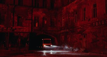 Movie still from “The Ugly Swans” (2006), directed by Konstantin Lopushanskiy – A car is driving through a tunnel in the dark; Extreme Wide shot, Low angle