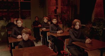 Movie still from “The Ugly Swans” (2006), directed by Konstantin Lopushanskiy – A group of children sitting at desks in a classroom; Wide shot, High angle