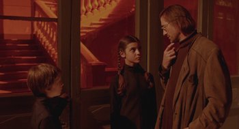 Movie still from “The Ugly Swans” (2006), directed by Konstantin Lopushanskiy – A group of people standing next to each other in a room; Medium shot, Over the shoulder angle