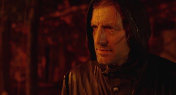 Movie still from “The Ugly Swans” (2006), directed by Konstantin Lopushanskiy – A person wearing a hooded jacket; Close Up shot, Low angle