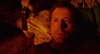 Movie still from “The Ugly Swans” (2006), directed by Konstantin Lopushanskiy – A person in a dark room; Close Up shot, High angle