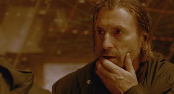 Movie still from “The Ugly Swans” (2006), directed by Konstantin Lopushanskiy – A person holding his hand to his face; Close Up shot, Low angle