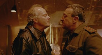 Movie still from “The Ugly Swans” (2006), directed by Konstantin Lopushanskiy – A couple of men standing next to each other; Close Up shot, Over the shoulder angle