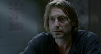 Movie still from “The Ugly Swans” (2006), directed by Konstantin Lopushanskiy – A person wearing glasses; Close Up shot, Over the shoulder angle